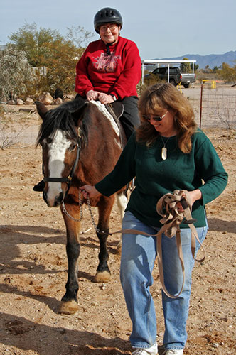 Oma Jutta riding a horse at Chile Acres in Tonopah, Arizona