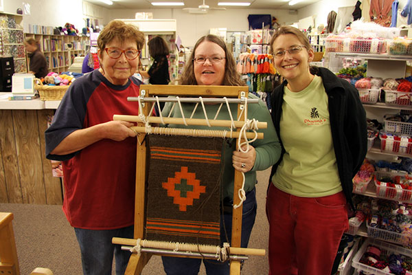 Jutta Engelhardt, Mary Walker, and Caroline Wise at Fiber Factory in Mesa, Arizona with Jutta’s finished Navajo Rug she made